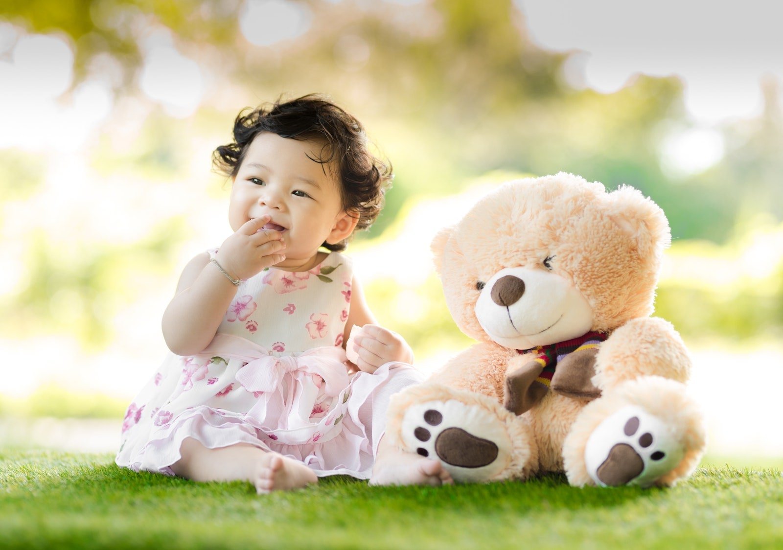 Smiling baby with teddy bear