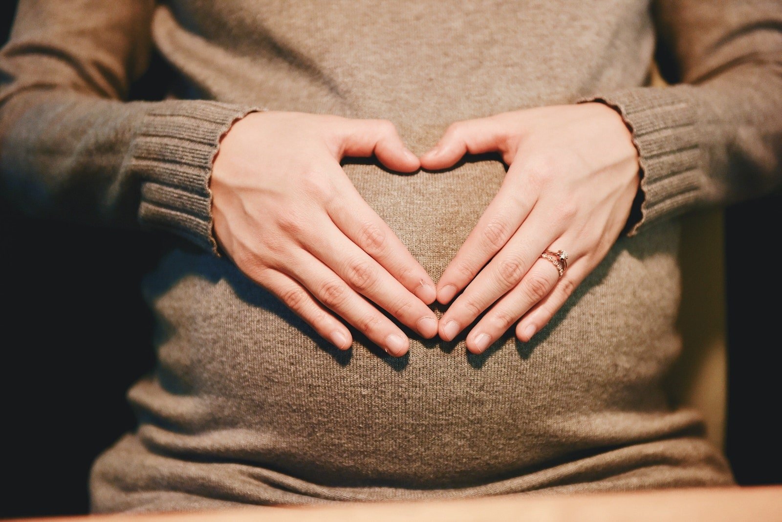 Heart hands expecting mom