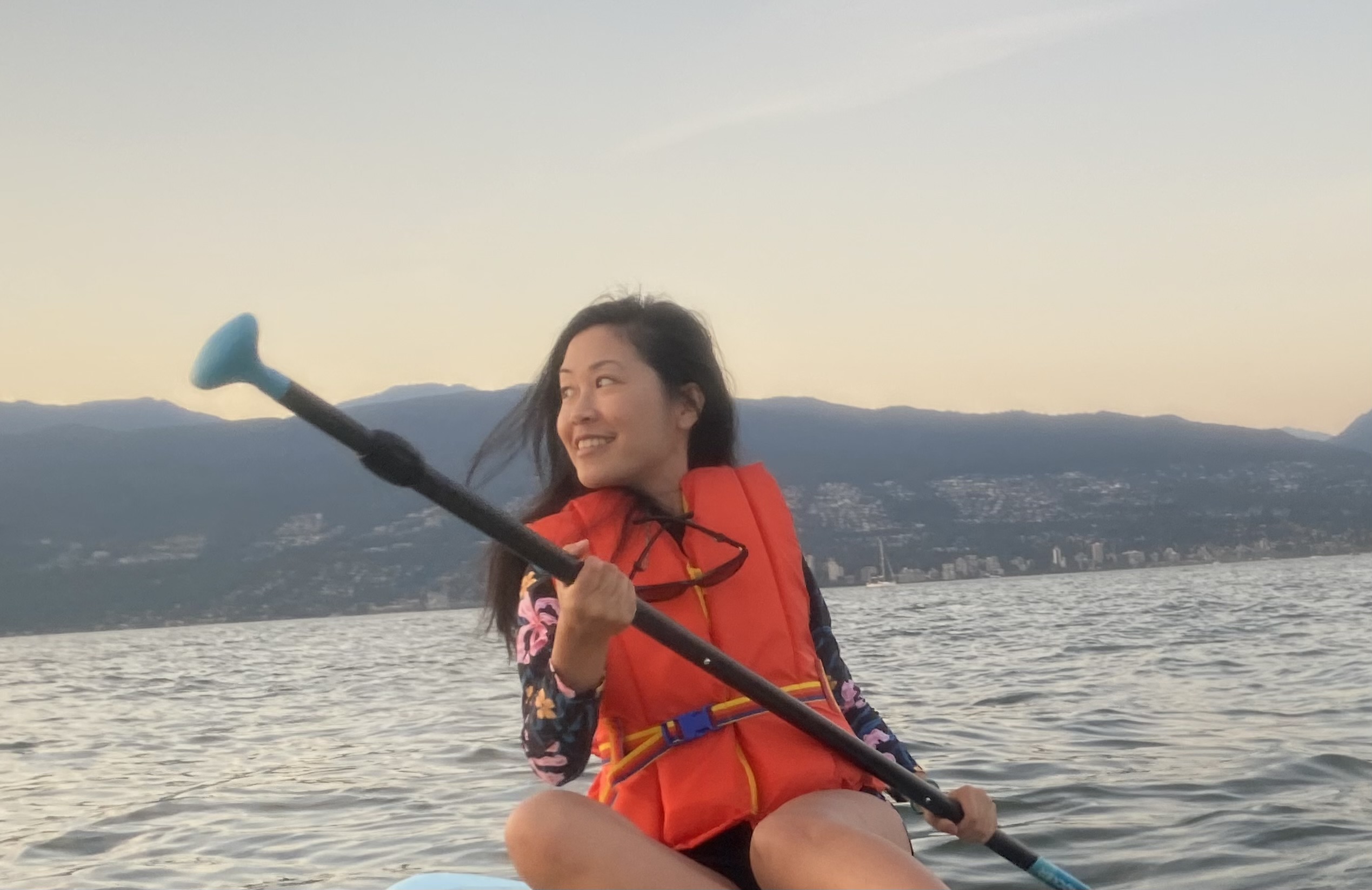 Lisa Nguyen - woman paddleboarding and smiling