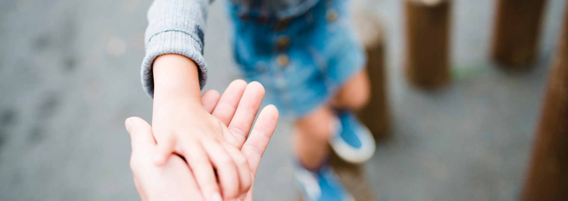 Enfant anxieux tenant la main d'un parent.
