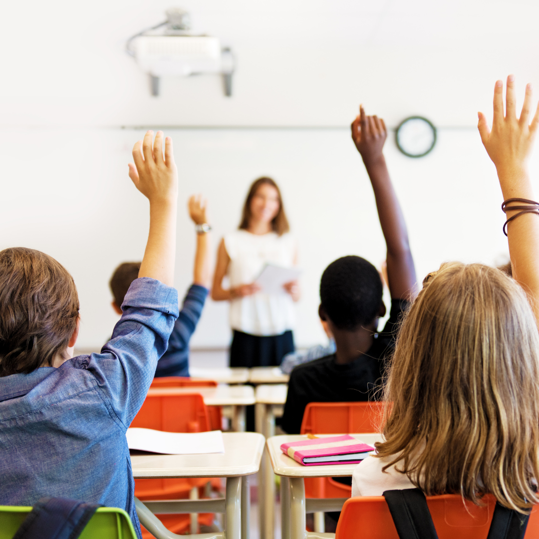 classroom - children with hands up